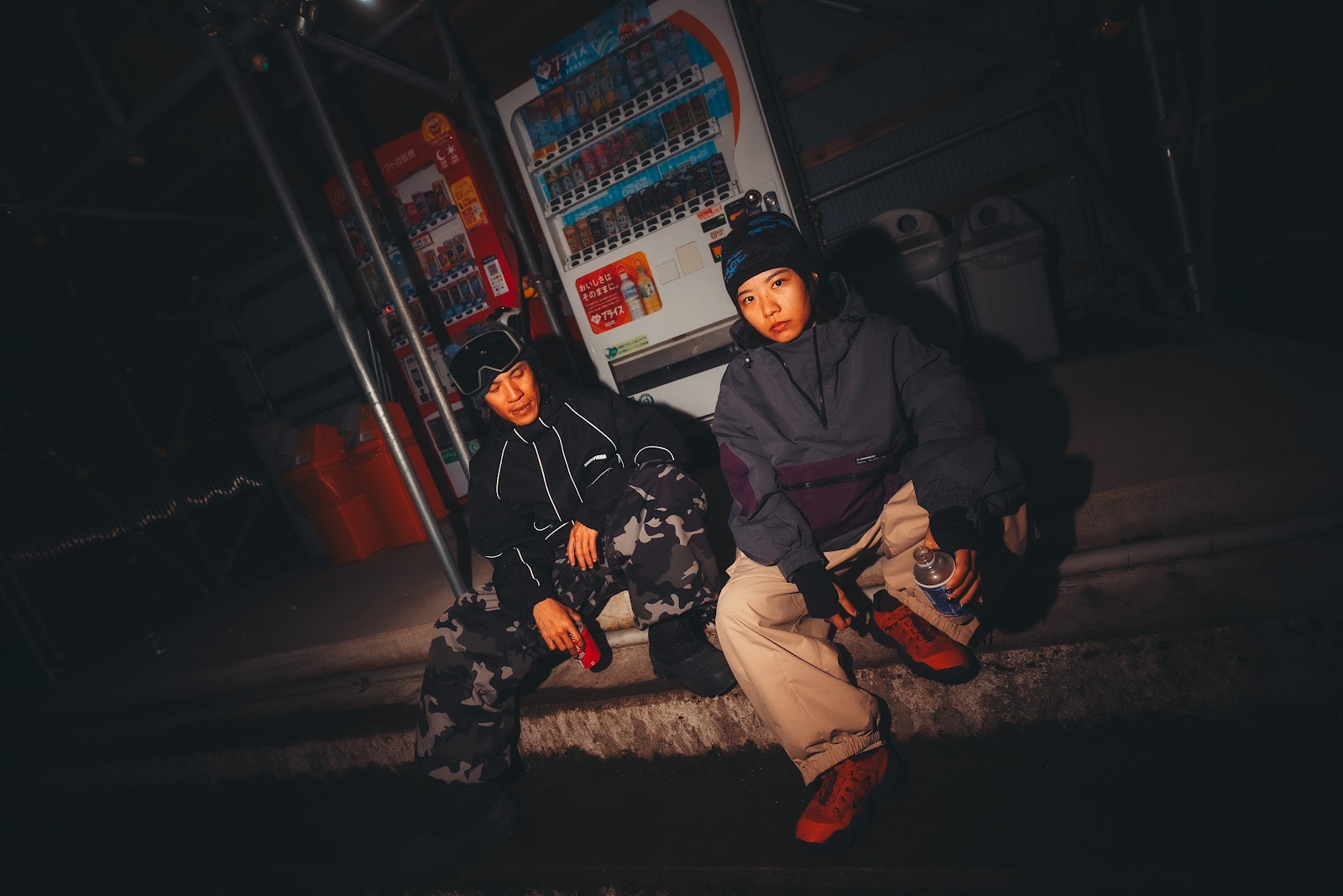 Two snowboarders taking a break on a snow trip